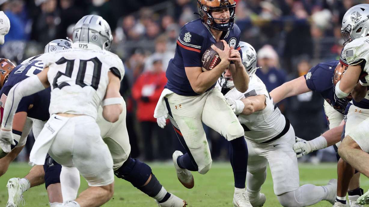 Navy quarterback Blake Horvath runs with the ball during the first half of an NCAA college football game against Army, Saturday, Dec. 13, 2025, in Baltimore.