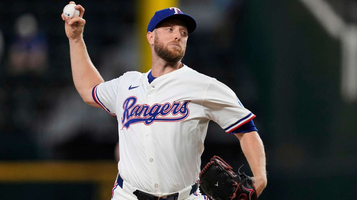 FILE - Texas Rangers starting pitcher Merrill Kelly throws to the Arizona Diamondbacks in the first inning of a baseball game, Aug. 13, 2025, in Arlington, Texas.