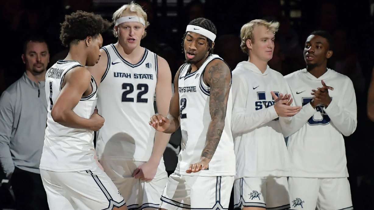 Utah State guard Elijah Perryman (1) and guard MJ Collins Jr. (2) dance during player introductions Saturday in Salt Lake City.