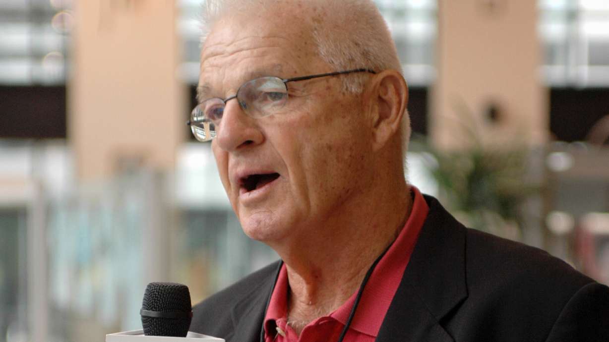 FILE - Paul Wiggin, defensive tackle for Stanford 1954-56, talks to a local radio station at a reception for players being enshrined into the College Football Hall of Fame, Aug. 10, 2006, in South Bend, Ind.