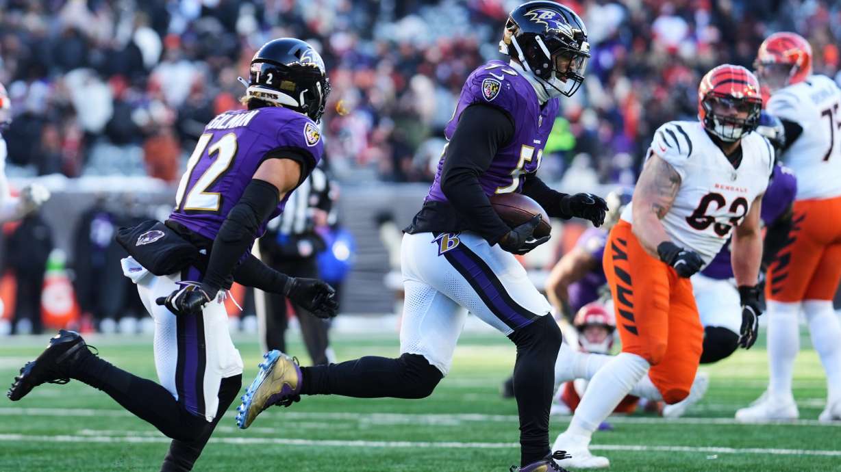 Baltimore Ravens linebacker Kyle Van Noy (53), with safety Alohi Gilman (12) running next to him, returns an interception during the second half of an NFL football game against the Cincinnati Bengals, Sunday, Dec. 14, 2025, in Cincinnati.
