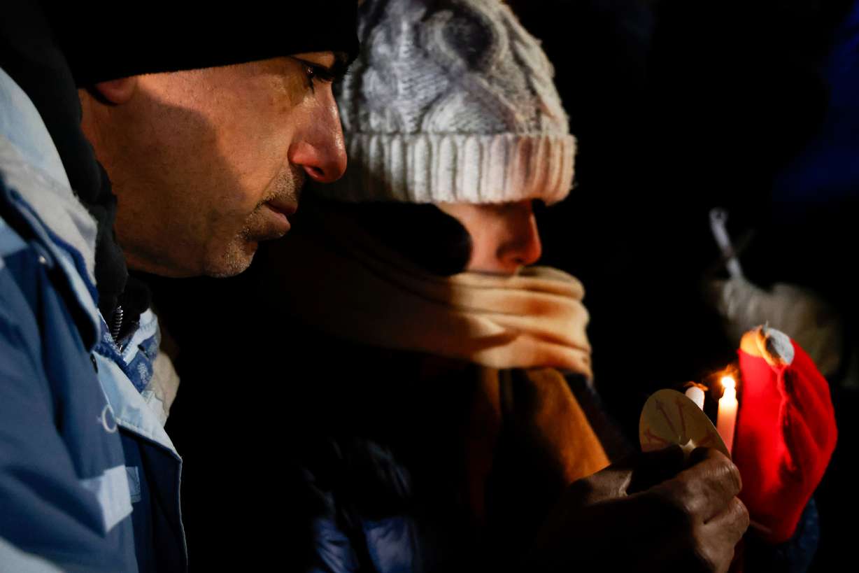 Providence and Brown University community members gather during a vigil at Lippitt Memorial Park, a day after a shooting occurred on the Brown University campus. Sunday, in Providence, R.I.