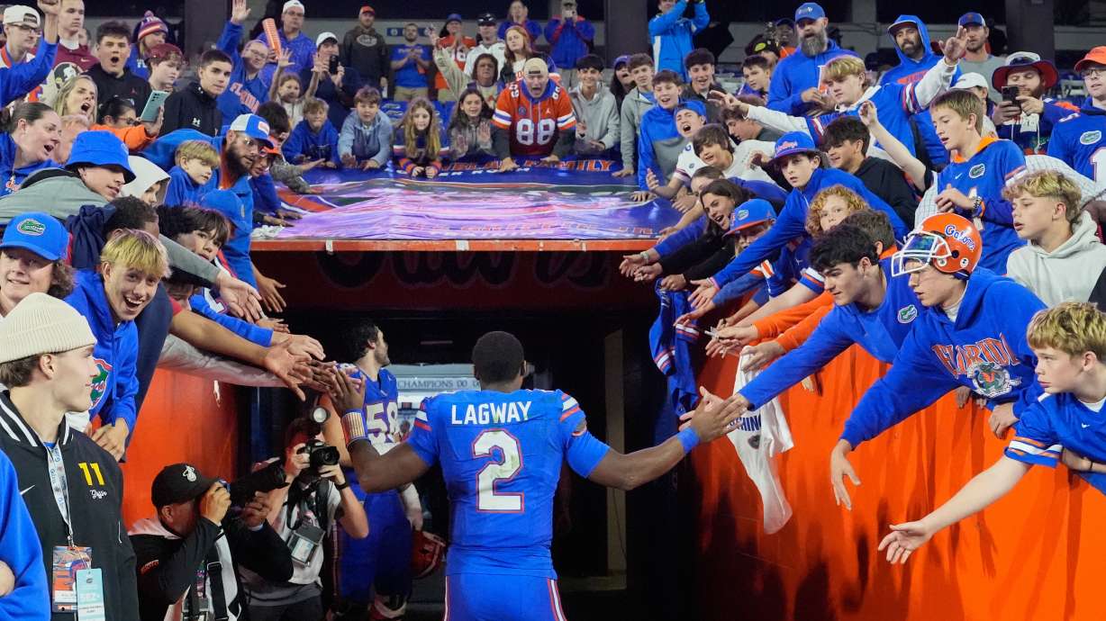 Florida quarterback DJ Lagway (2) high fives fans as he leave the field during the second half of an NCAA college football game, Saturday, Nov. 29, 2025, in Gainesville, Fla.