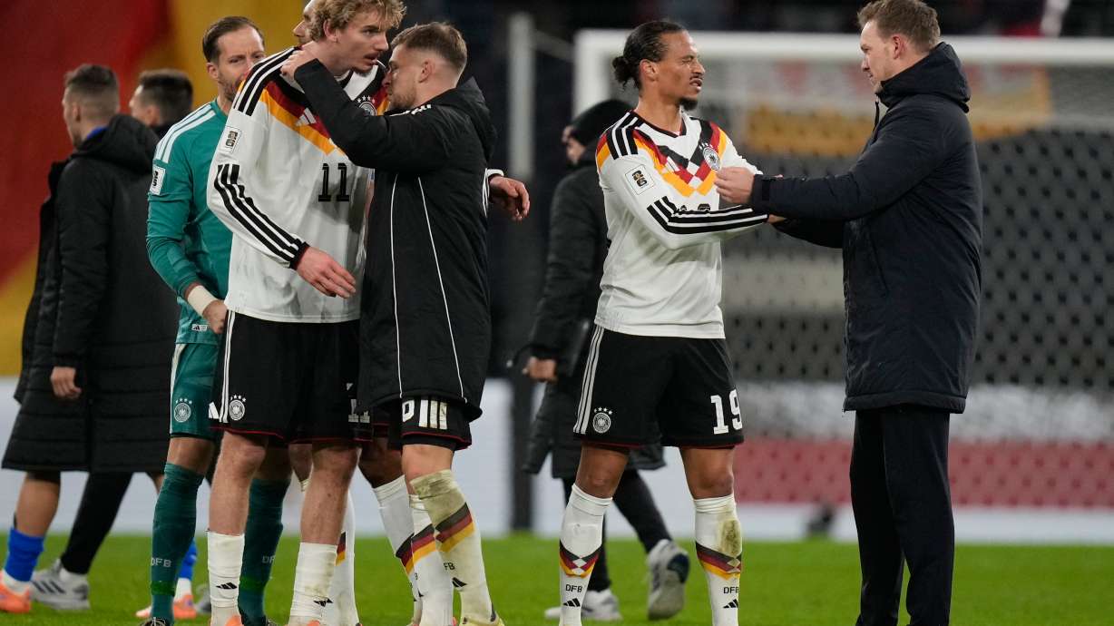 Germany's coach Julian Nagelsmann congratulates Leroy Sané after a group A World Cup qualifiying soccer match between Germany and Slovakia in Leipzig, Germany, Monday, Nov. 17, 2025.