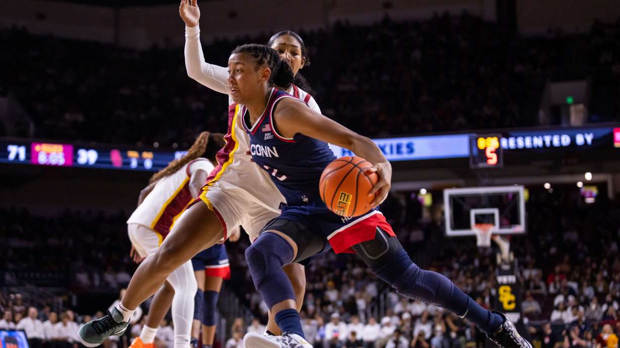 UConn guard Kk Arnold (2) drives the ball against Southern California during the second half of an NCAA college basketball game Saturday, Dec. 13, 2025, in Los Angeles.