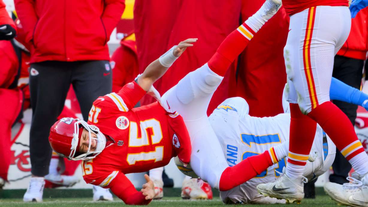 Kansas City Chiefs quarterback Patrick Mahomes (15) is injured after being tackled by Los Angeles Chargers defensive tackle Da'Shawn Hand (91) during the second half of an NFL football game, Sunday, Dec. 14, 2025 in Kansas City, Mo.