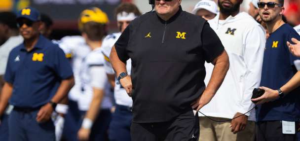 Biff Poggi tells signees and parents Michigan hopes to hire a coach by end of month, AP source says