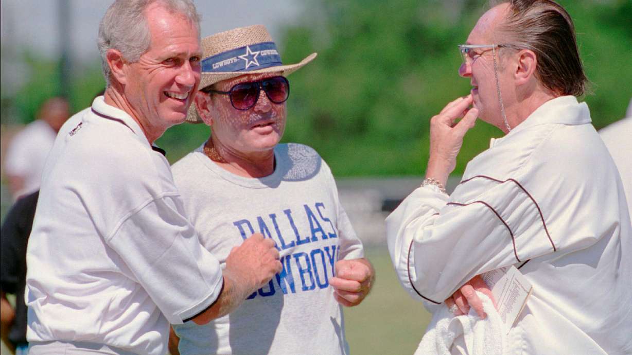 FILE - Oakland Raiders head football coach Mike White, left, speaks with Dallas Cowboys offensive coordinator Ernie Zampese, and Raiders owner Al Davis, right, after the teams worked out, in Austin, Texas, Aug. 1, 1995.