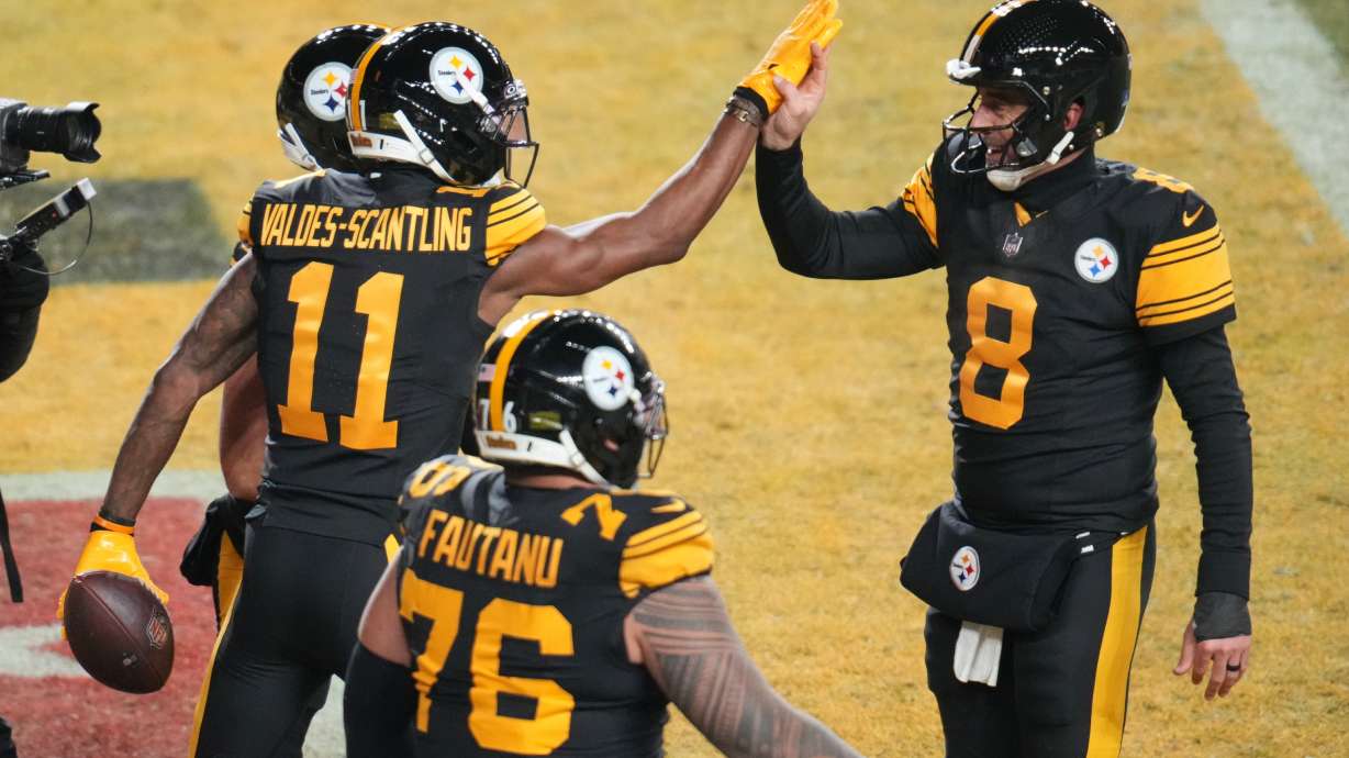 Pittsburgh Steelers' Marquez Valdes-Scantling (11), Aaron Rodgers (8) and Troy Fautanu (76) celebrate after Marquez Valdes-Scantling caught a touchdown pass in the second half of an NFL football game against the Miami Dolphins in Pittsburgh, Monday, Dec. 15, 2025.