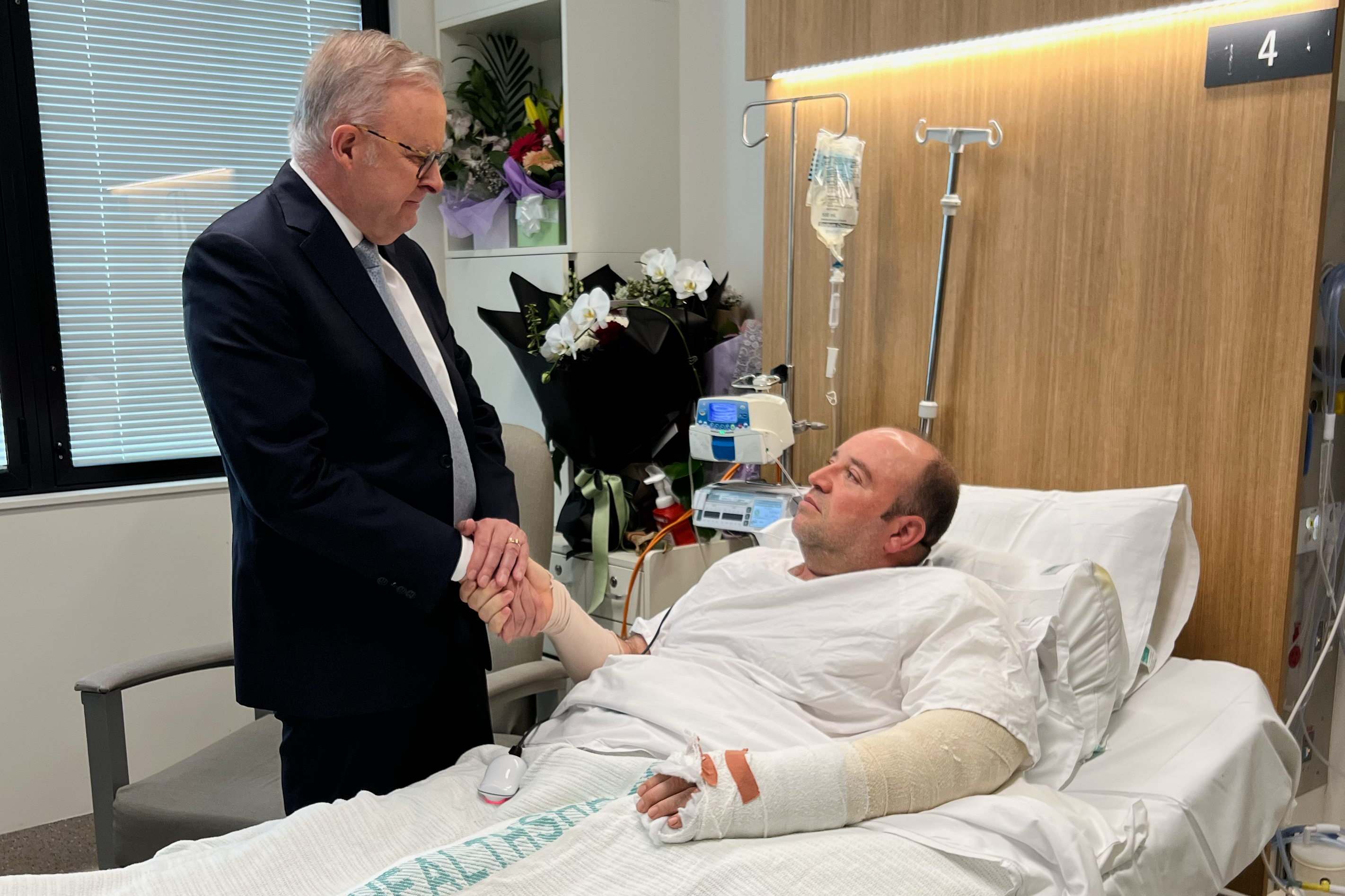 Australian Prime Minister Anthony Albanese meets Ahmed al Ahmed at St George Hospital in Sydney, Tuesday. Al Ahmed was due to undergo surgery Wednesday after he was able to disarm one of the gunmen at the Bondi Beach attack.