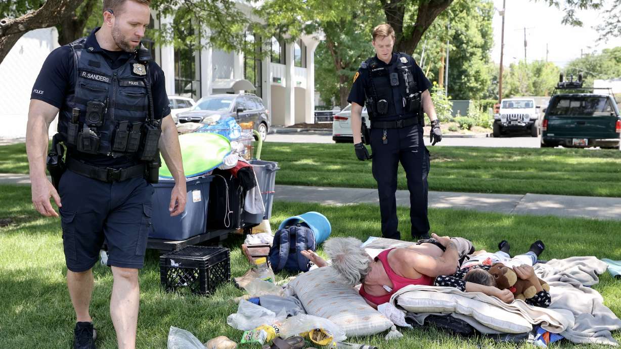Salt Lake City Police Sgt. Ryan Sanders and officer Kent Krzymowski speak with two people experiencing homelessness on July 16. Salt Lake County is working with a former Florida judge on changes to its criminal justice system, which it hopes can address criminal justice issues and reduce homelessness.