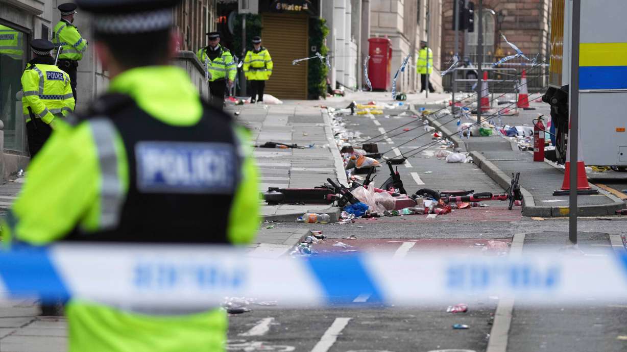 FILE - Police guards the site where a 53-year-old British man plowed a minivan into a crowd of Liverpool soccer fans who were celebrating the city's Premier League championship Monday, injuring more than 45 people in Liverpool, England, Tuesday, May 27, 2025.