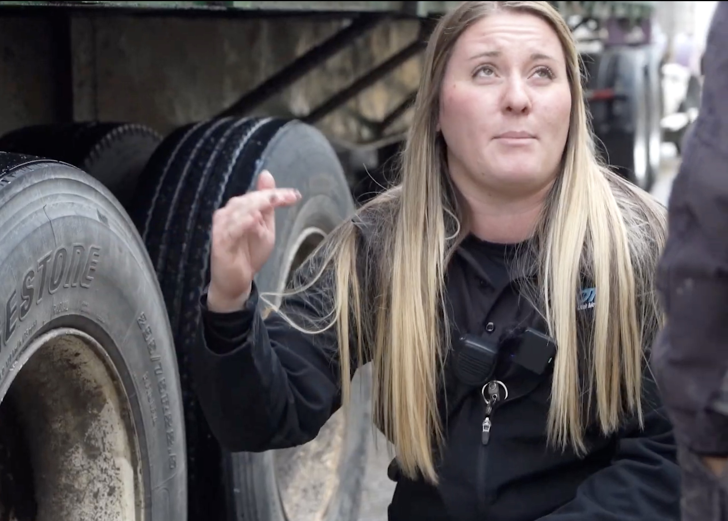 Cheyenne Enns, an agent for the Utah Department of Transportation's Echo Port of Entry, informs a semitruck driver of a flat tire detected by the port's in-road tire anomaly detector. The system helps inspectors better identify issues with tires.