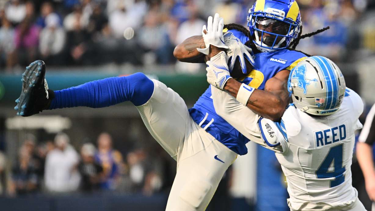 Los Angeles Rams wide receiver Davante Adams (17) makes a catch over Detroit Lions cornerback D.J. Reed (4) during the first half of an NFL football game Sunday, Dec. 14, 2025, in Inglewood, Calif.