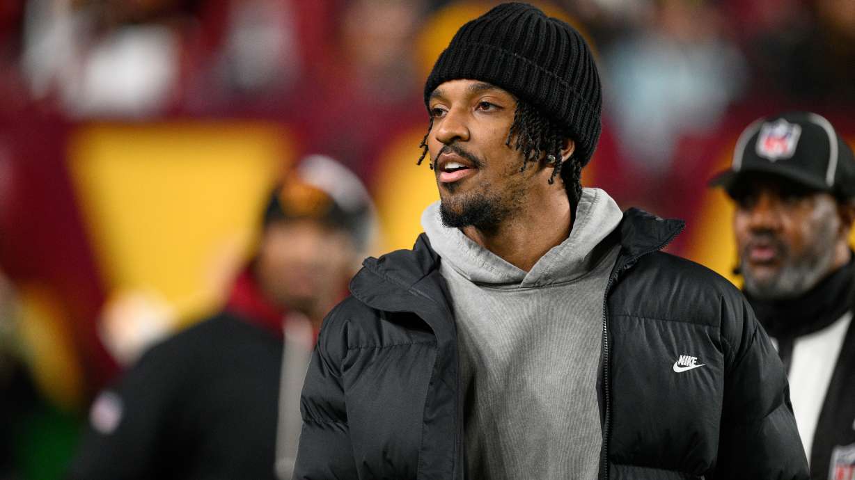 Washington Commanders quarterback Jayden Daniels is seen on the sidelines before an NFL football game against the Denver Broncos Sunday, Nov. 30, 2025, in Landover, Md.