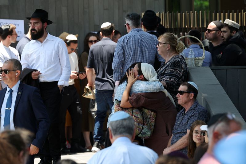 Mourners attend the funeral of Rabbi Eli Schlanger, who was killed during a shooting at Sydney's Bondi Beach on Sunday, at Chabad of Bondi synagogue, in Sydney, Australia, Wednesday. Funerals for victims of the shooting at Bondi Beach began as leaders moved to consider emergency gun reforms.