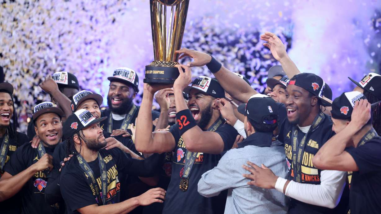 New York Knicks center Karl-Anthony Towns (32) celebrates with teammates after his team's victory against the San Antonio Spurs in the NBA Cup championship basketball game Tuesday, Dec. 16, 2025, in Las Vegas.