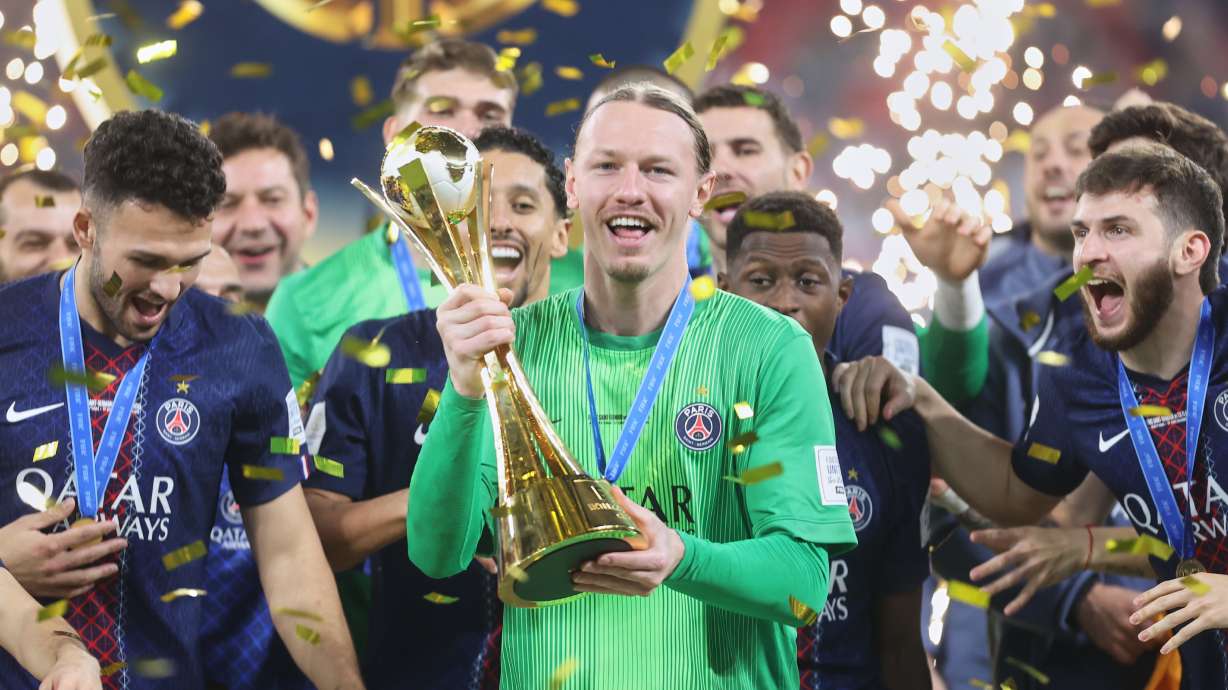 PSG's goalkeeper Matvey Safonov holds the trophy after winning the FIFA Intercontinental Cup final soccer match between Flamengo and Paris Saint-Germain in Doha, Qatar, Wednesday, Dec. 17, 2025.