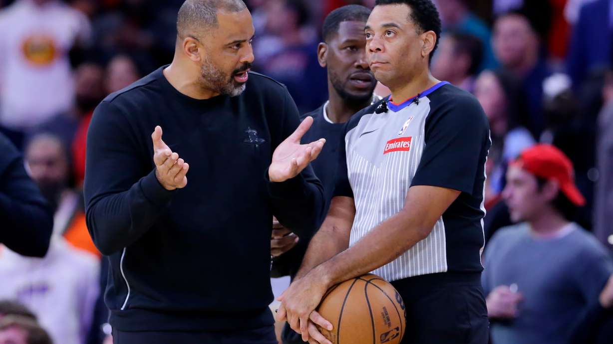 Houston Rockets head coach Ime Udoka, left, appeals to official Kari Lane, right, as a possible flagrant foul call against Jabari Smith Jr. is reviewed in the last 14 seconds of the second half of an NBA basketball game against the LA Clippers Thursday, Dec. 11, 2025, in Houston.