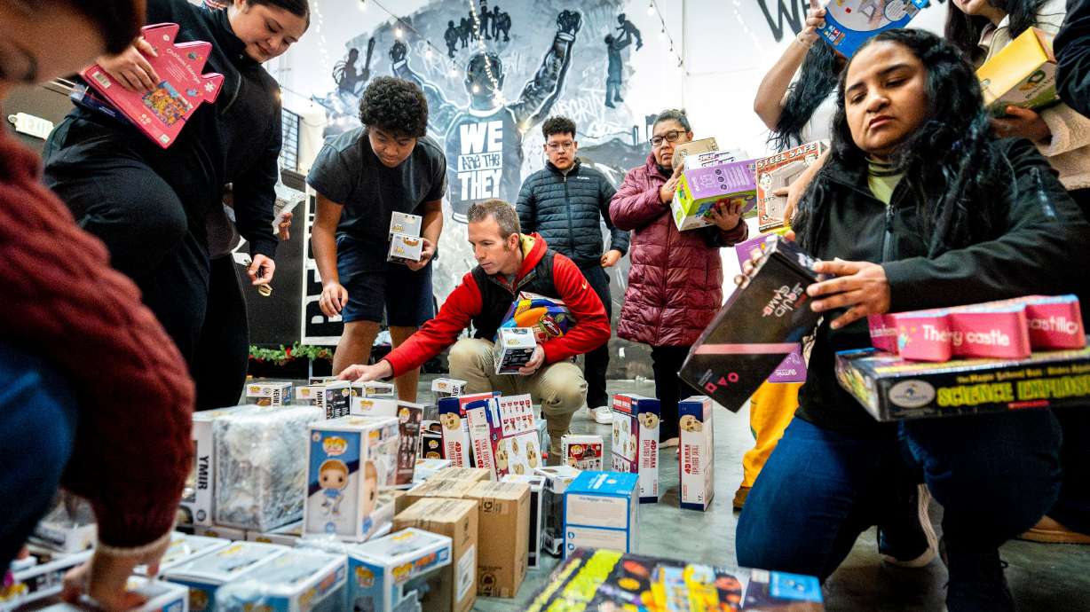 People browse and take toys during a toy drive at the headquarters of We Are The They in Lehi on Wednesday.