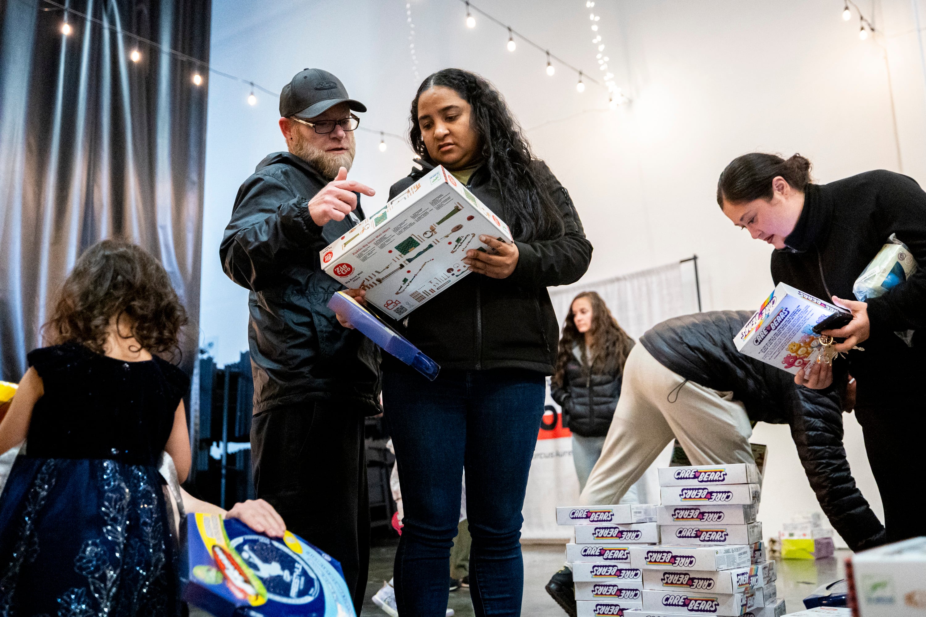 Corry Donathan, left, and Yadira Campo, both of South Jordan, check out toys during a toy drive at the headquarters of We Are The They in Lehi on Wednesday.