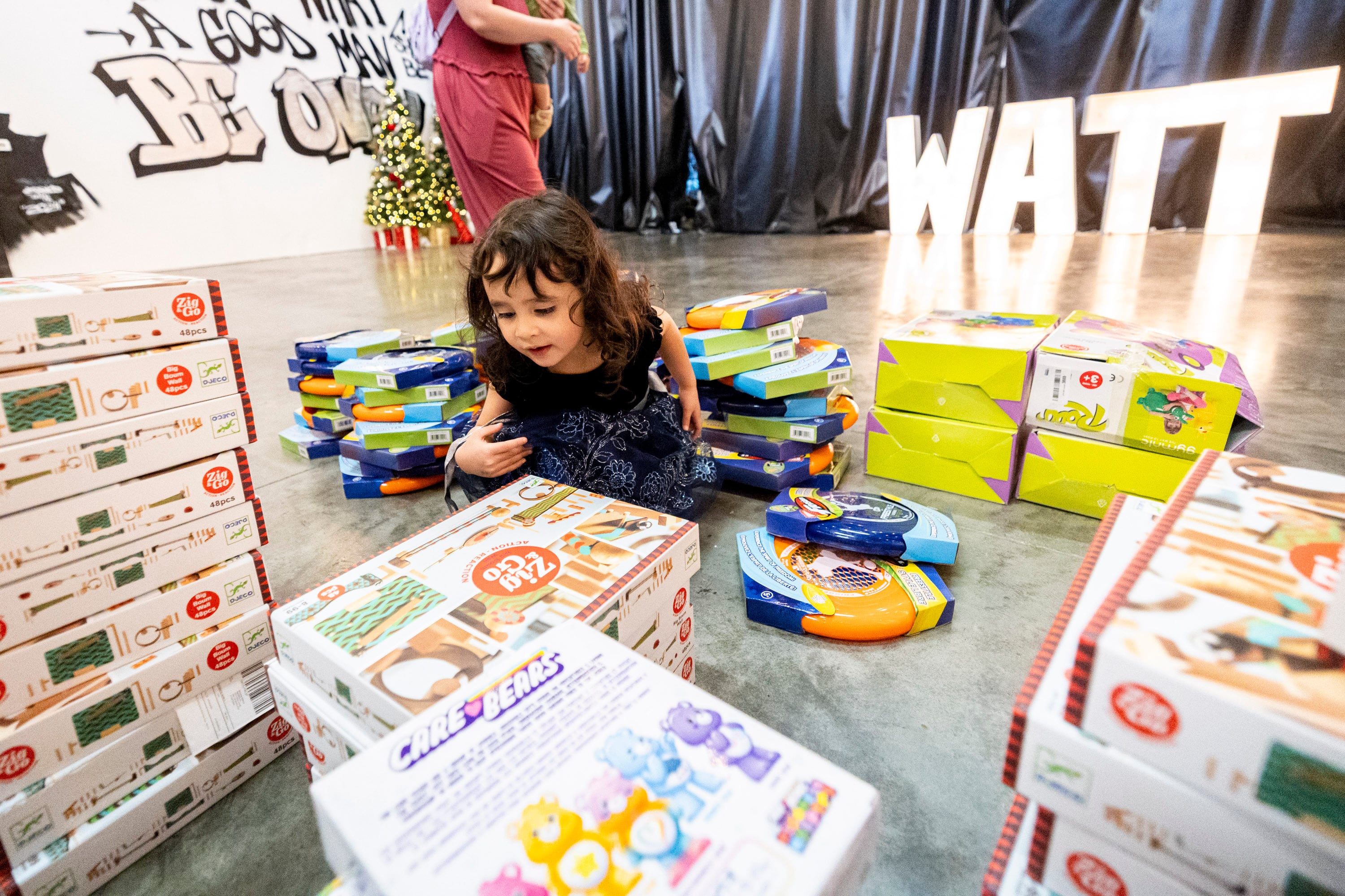 Evelyn Celebrado, 3, of West Jordan, checks out stacks of toys during a toy drive at the headquarters of We Are The They in Lehi on Wednesday.