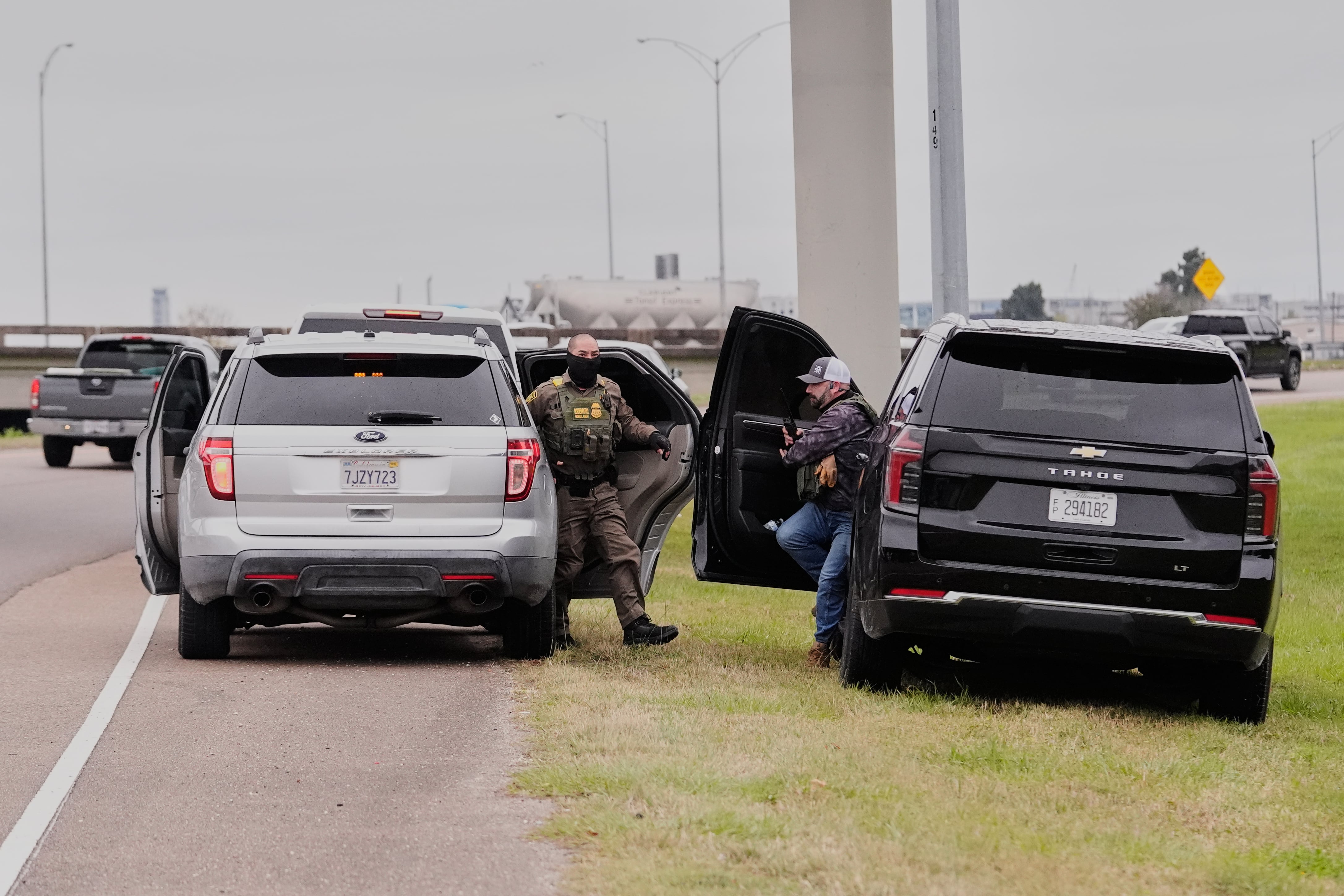Customs and Border Patrol agents question occupants of a vehicle they pulled over, during an immigration crackdown in Kenner, La., Dec. 5.