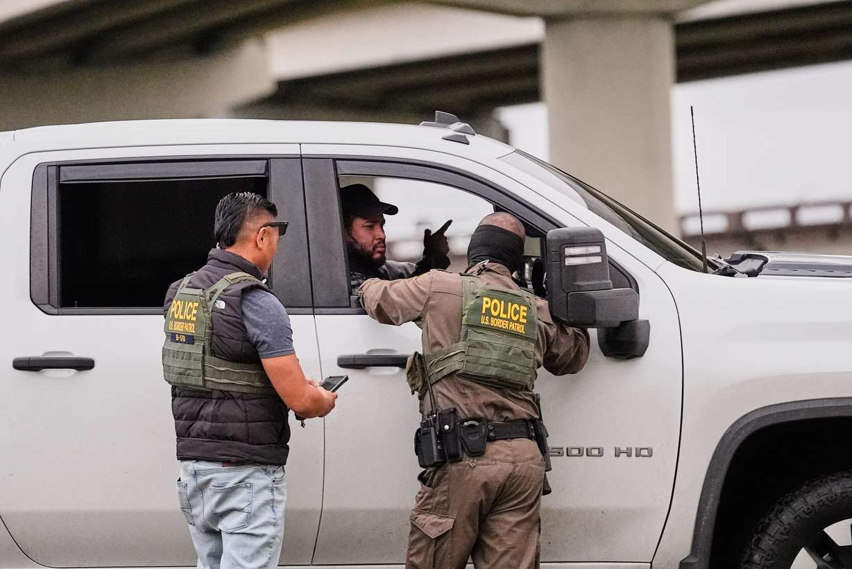 Customs and Border Patrol agents question occupants of a vehicle they pulled over, during an immigration crackdown in Kenner, La., Dec. 5.