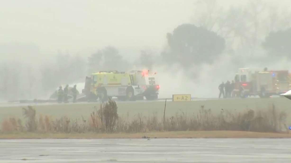 This screengrab made from video provided by WSOC shows firefighting crews responding to a reported plane crash at a regional airport in Statesville, N.C., erupting in a large fire, Thursday, Dec. 8, 2025.