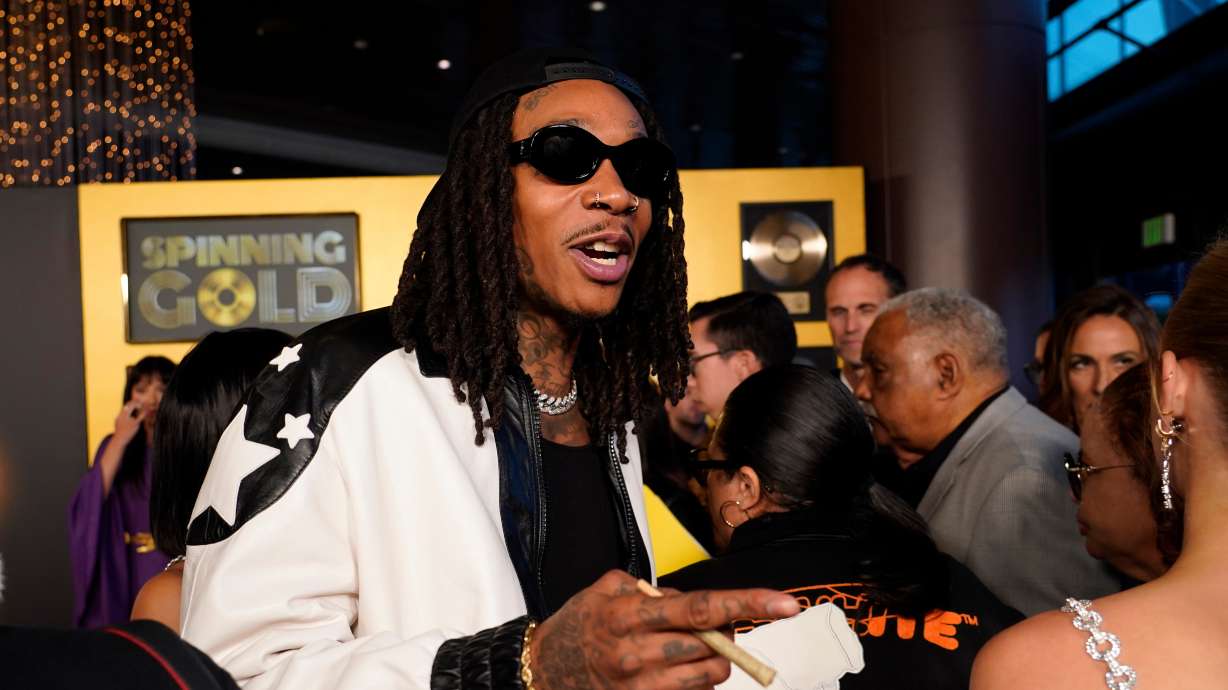 Wiz Khalifa, a cast member in "Spinning Gold," arrives at the premiere of the film, March 29, 2023, at the Directors Guild of America in Los Angeles. A Romanian court sentenced the rapper to 9 months in jail for drug possession.