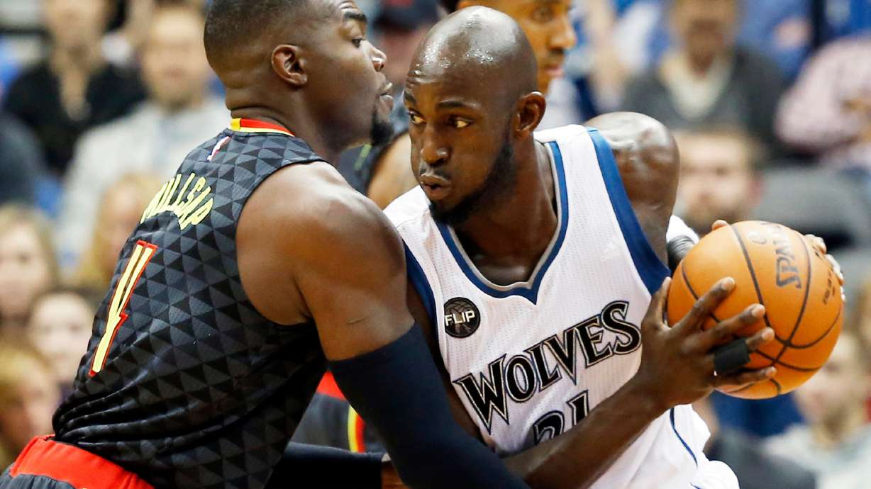 FILE - Minnesota Timberwolves' Kevin Garnett, right, drives against Atlanta Hawks' Paul Millsap in the first quarter of an NBA basketball game in Minneapolis, Nov. 25, 2015.