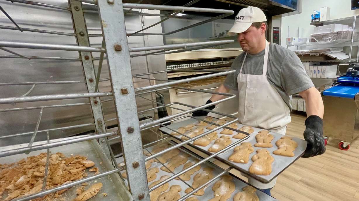 Lance DeRyke, of Topper Bakery in Ogden, places a freshly baked batch of speculaas cookies on a rack to cool on Wednesday. The locale is offering its Christmastime treats for the first time in five years.