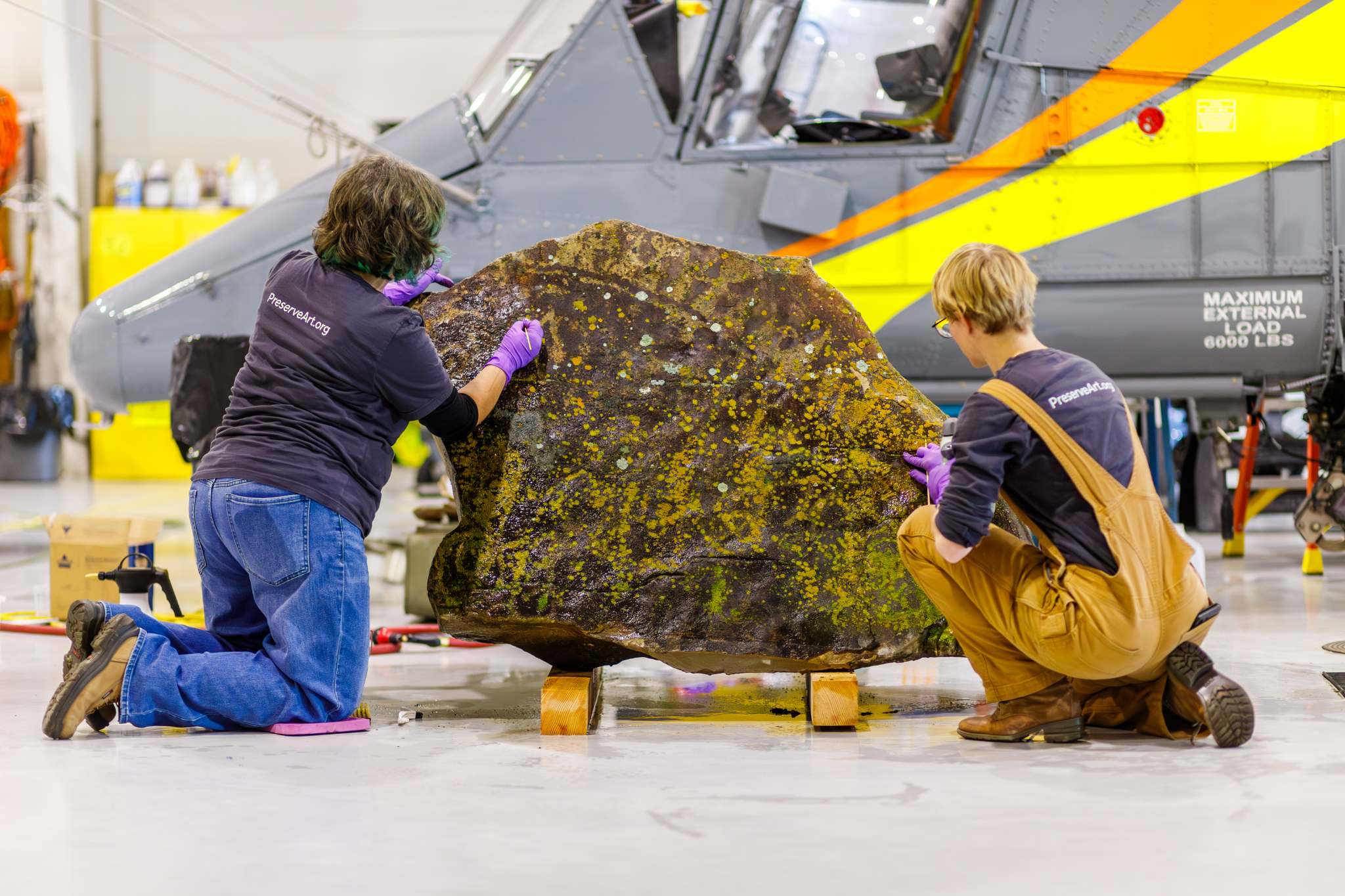 Conservators from the Midwest Art Conservation Center carefully clean and preserve this lichen-covered petroglyph on Dec. 9, in Provo. Ancestors of the Northwestern Band of the Shoshone Nation created the engraving 1,200 years ago.