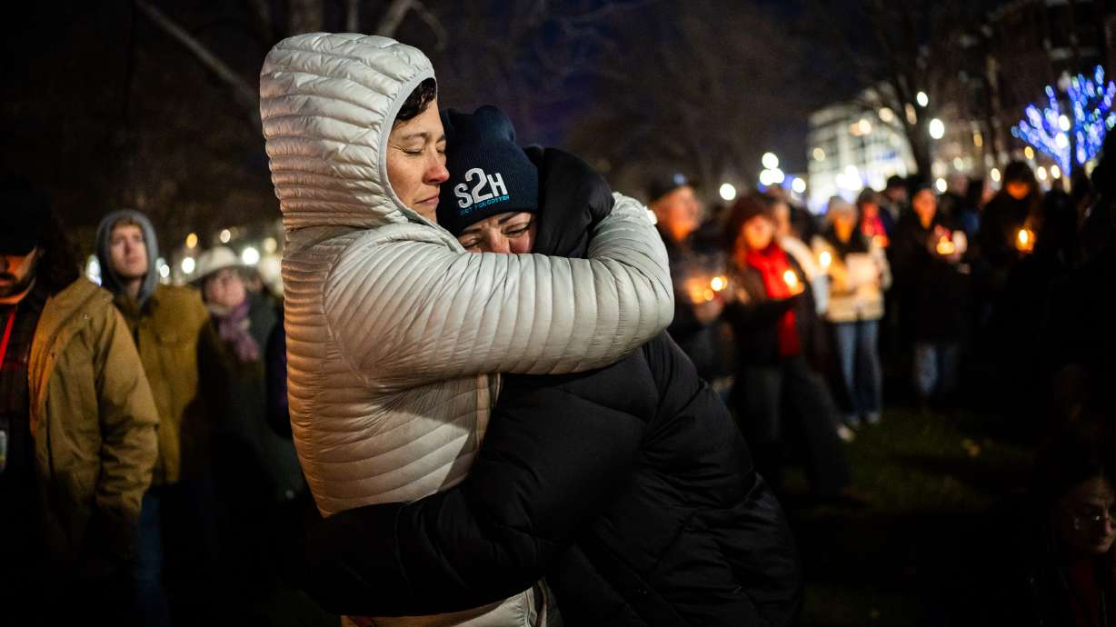 Jasmin Charles, left, and Kari Shepherd, right, colleagues in the recovery community, embrace during the 2025 Homeless Persons' Memorial Vigil at Pioneer Park in Salt Lake City on Thursday.