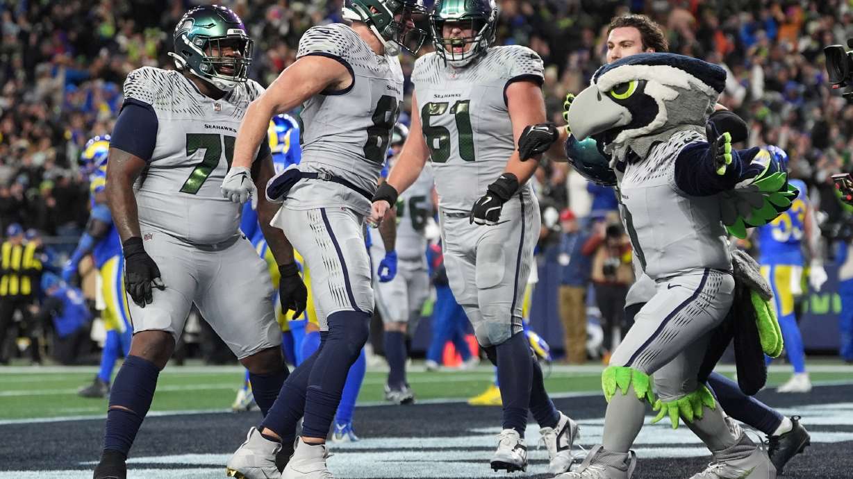Seattle Seahawks tight end Eric Saubert, second from left, celebrates after making a two-point conversion during overtime in an NFL football game against the Los Angeles Rams, Thursday, Dec. 18, 2025, in Seattle.