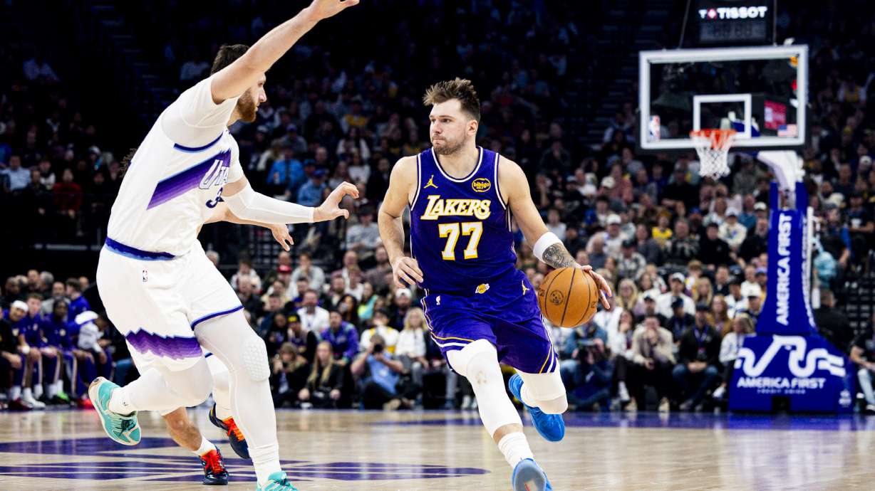 Los Angeles Lakers guard Luka Don?i? (77) drives the ball toward the basket while guarded by Utah Jazz center Jusuf Nurki? (30) during an NBA game held at the Delta Center in Salt Lake City on Thursday, Dec. 18, 2025.