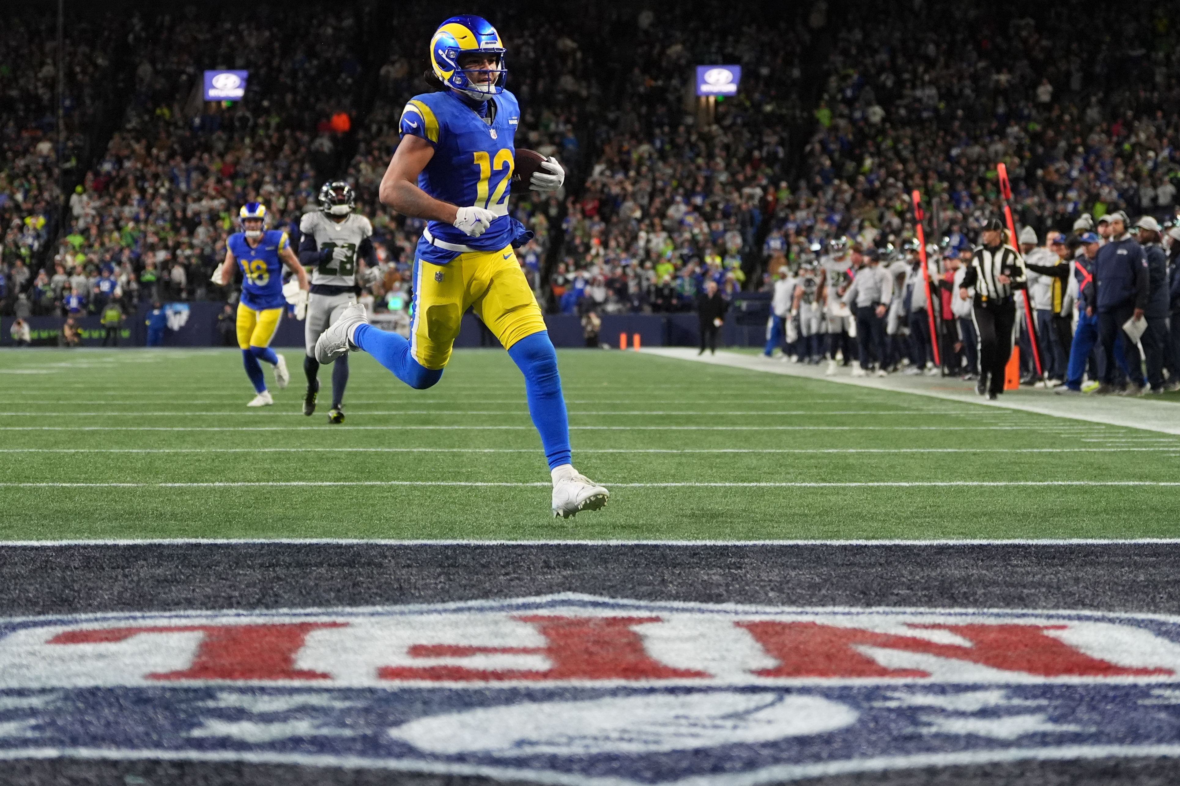 Los Angeles Rams wide receiver Puka Nacua scores a touchdown during overtime in an NFL football game against the Seattle Seahawks, Thursday, Dec. 18, 2025, in Seattle.