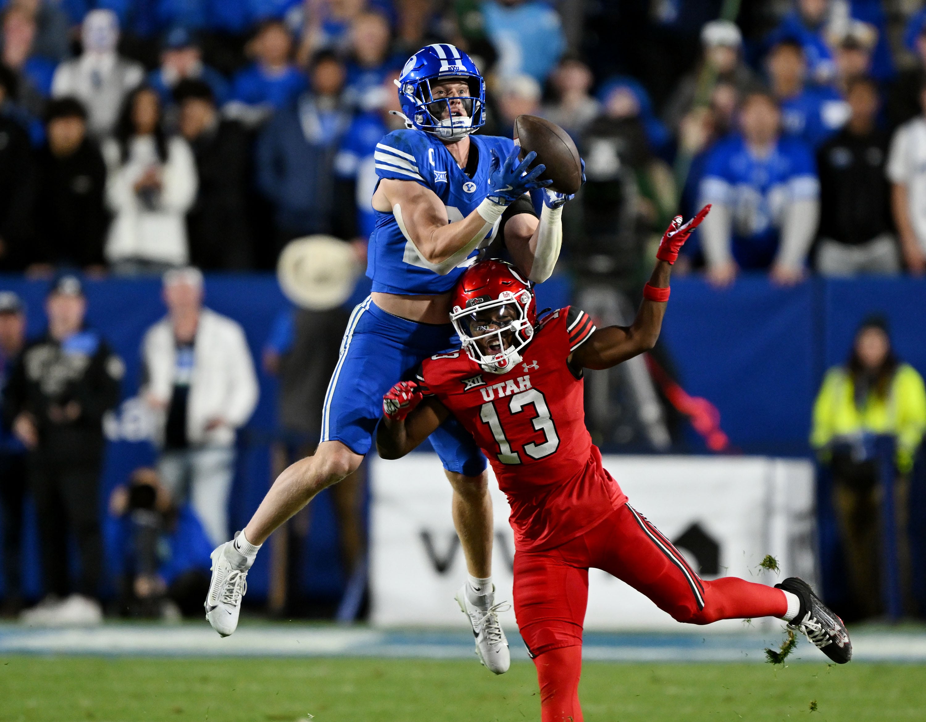 BYU safety Tanner Wall (28) intercepts a pass over Utah running back Daniel Bray (13) as BYU and Utah play at LaVell Edwards Stadium in Provo on Saturday, Oct. 18, 2025.