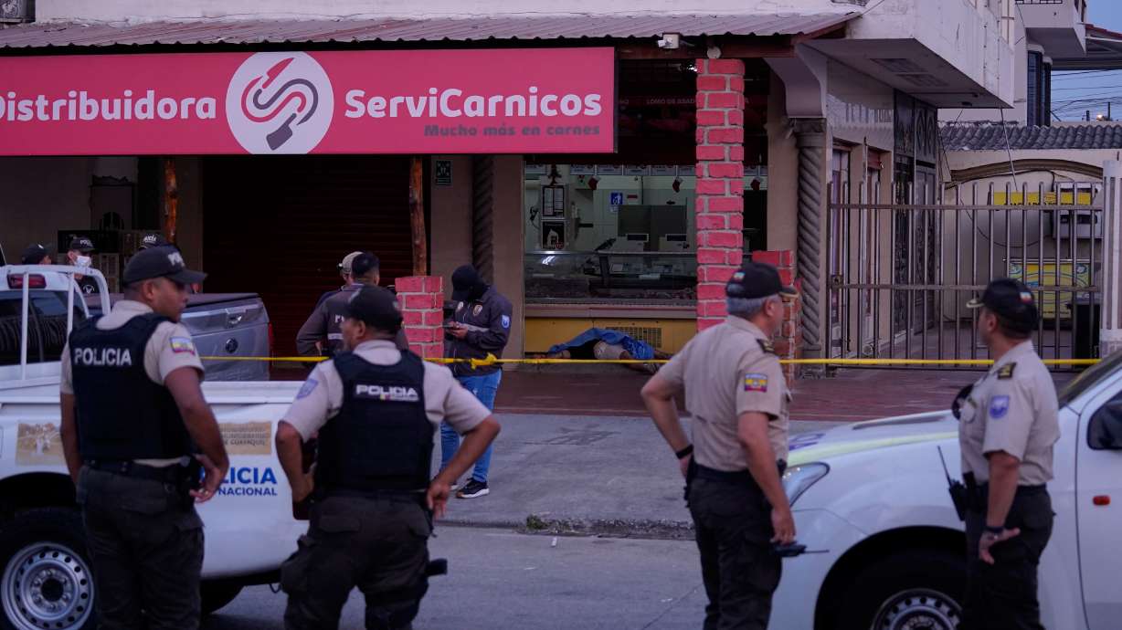 Police work the scene as the body of slain soccer player Mario Pineida lies on the floor at a butcher shop in Guayaquil, Ecuador, Wednesday, Dec. 17, 2025.