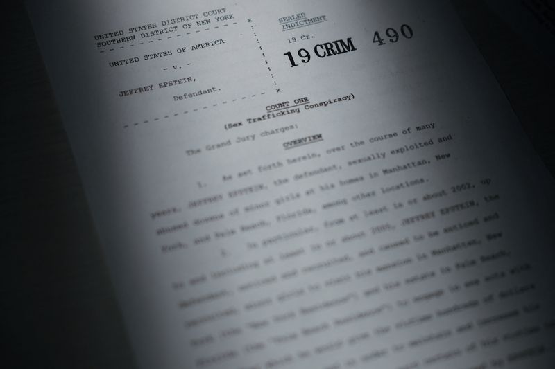 A newly unsealed indictment of Jeffrey Epstein is seen in this handout image released by the Justice Department and printed and arranged for a photograph in Washington, Friday. Over 300,000 pages of records were released by the department.