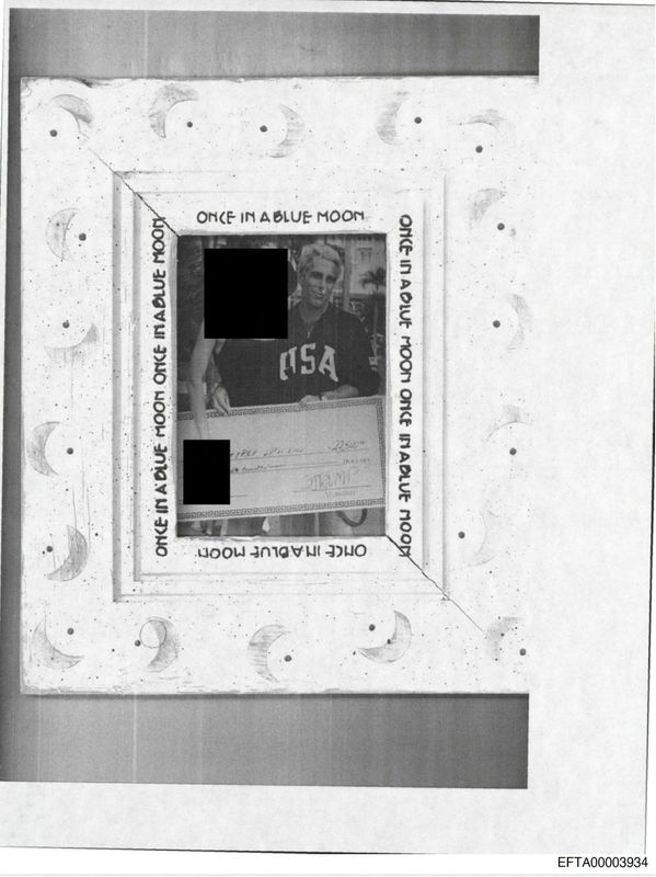 A photo of Jeffrey Epstein appearing to hold a check with Trump's name on it is shown in this image from Epstein's estate, released by the Department of Justice in Washington, on Friday. More than 1,200 names are identified in the release of over 300,000 documents.