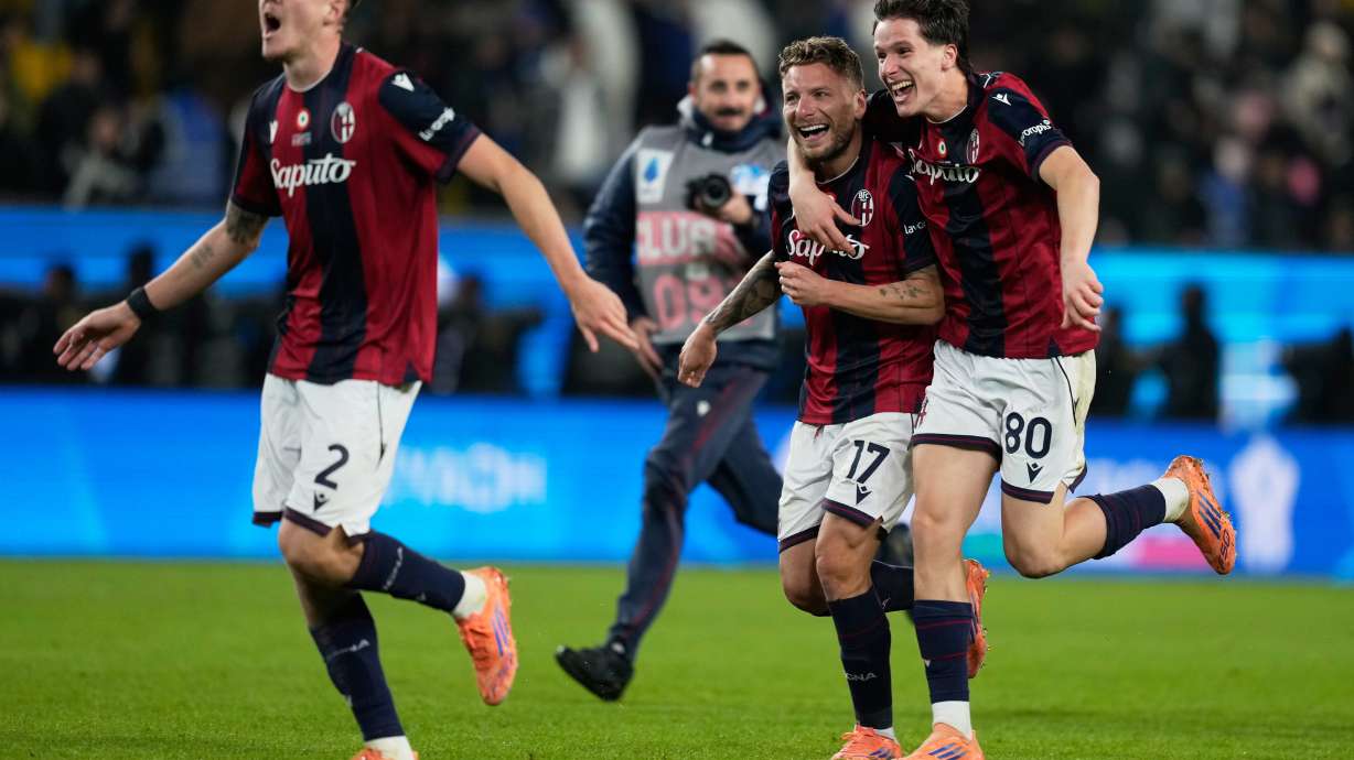 Bologna's Ciro Immobile, center, celebrates with teammates Emil Holm, left, and Giovanni Fabbian after scoring the winning goal during a penalty shoot out at the end of an Italian Super Cup semi-final soccer match between Bologna and Inter Milan in Riyadh, Saudi Arabia, Friday, Dec. 19, 2025.