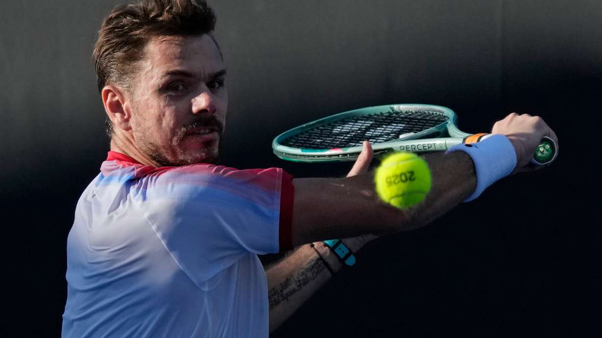 FILE - Stan Wawrinka, of Switzerland, plays a backhand return to Lorenzo Sonego, of Italy, during a first-round match at the Australian Open tennis championship in Melbourne, Australia, Jan. 14, 2025.