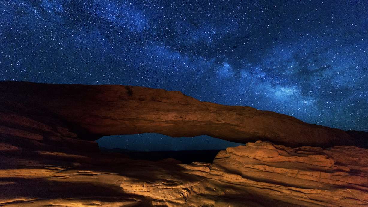 The Milky Way is visible over Mesa Arch at Canyonlands National Park in Utah. It might be one of the better options to view the night sky during the winter solstice on Sunday.