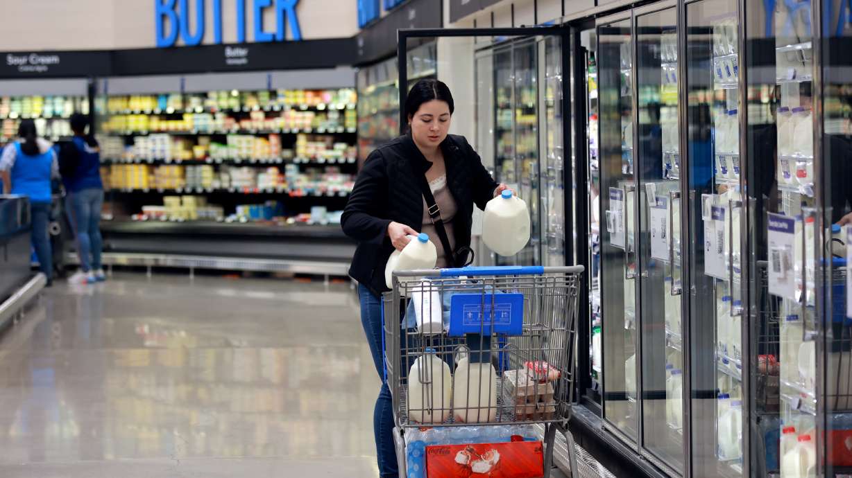 Blanca Sanchez shops for milk at a Walmart Supercenter in West Valley City on Oct. 31. The latest round of economic data shows Utah's indicators are remaining steadier than national trends.