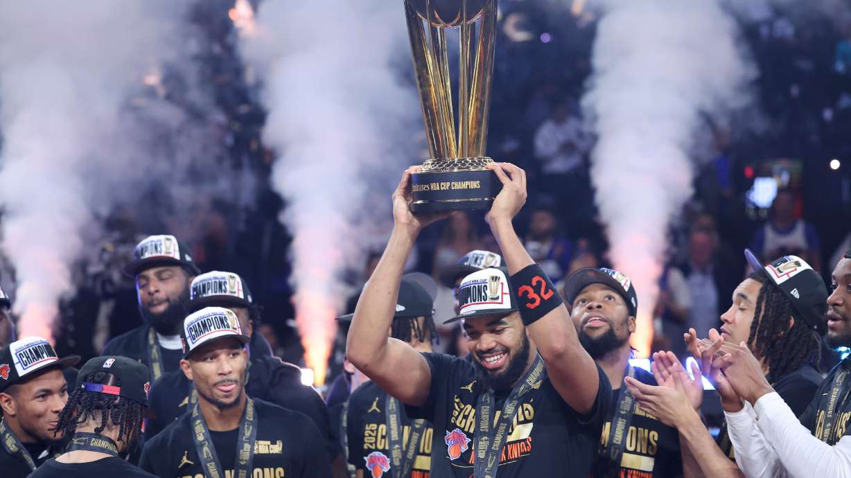 New York Knicks center Karl-Anthony Towns (32) celebrates with teammates after his team's victory against the San Antonio Spurs in the NBA Cup championship basketball game Tuesday, Dec. 16, 2025, in Las Vegas.