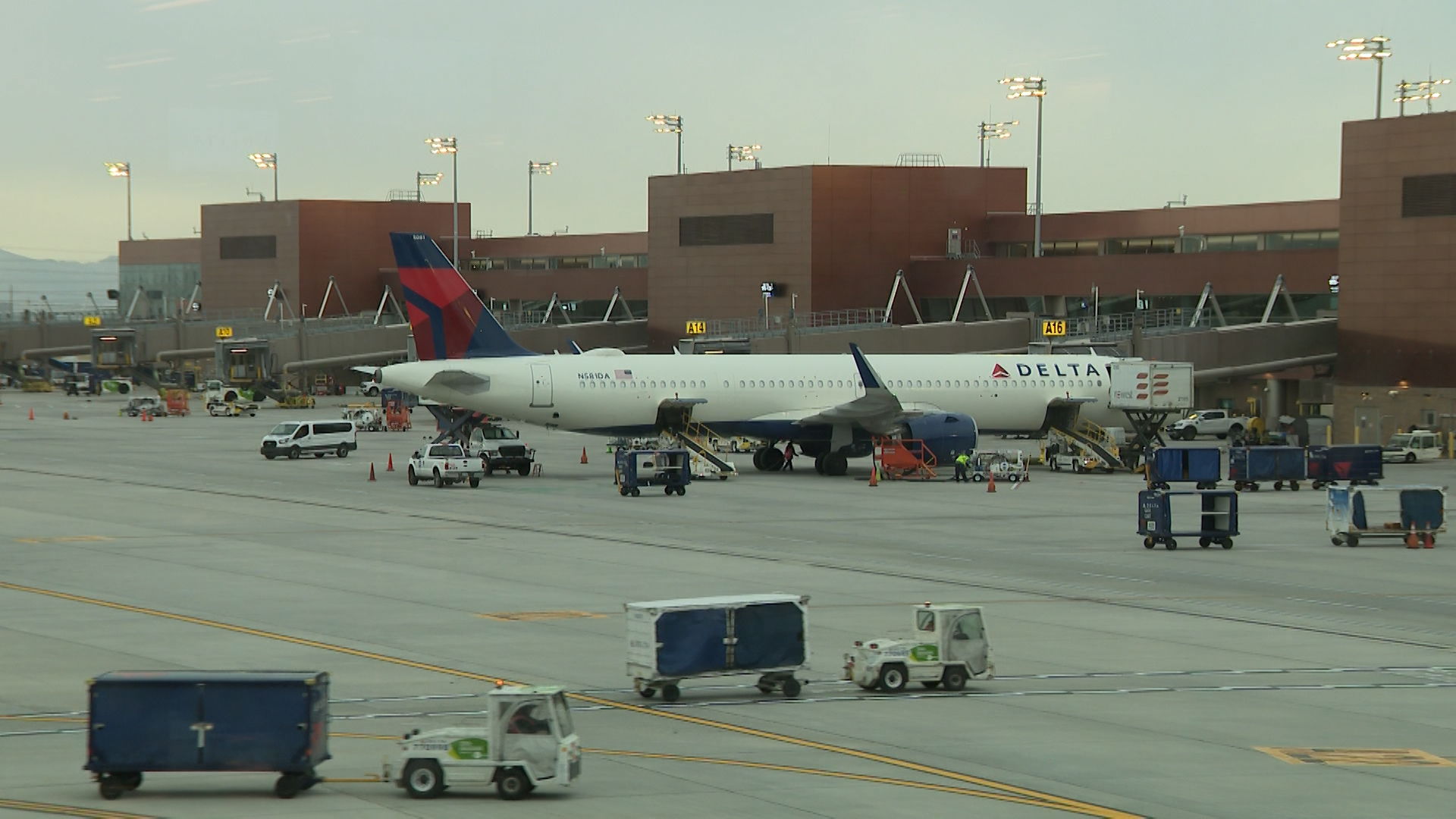 A Delta Air Lines plane sits at the gate at Salt Lake City International Airport, Friday. Officials are advising travelers to arrive much earlier than normal due to the start of holiday travel.