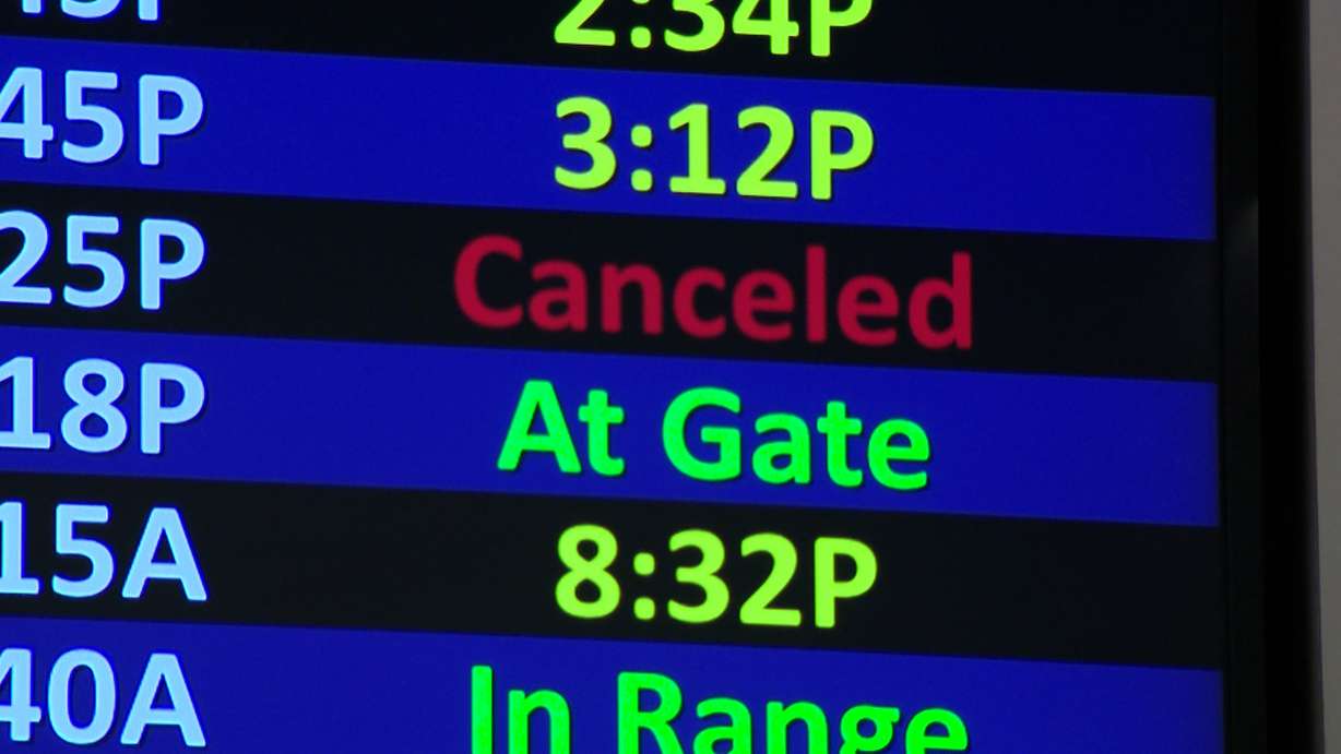 A flight display board at Salt Lake City International Airport is pictured on Friday. Officials expected over 300,000 travelers to pass through the airport on Friday alone.