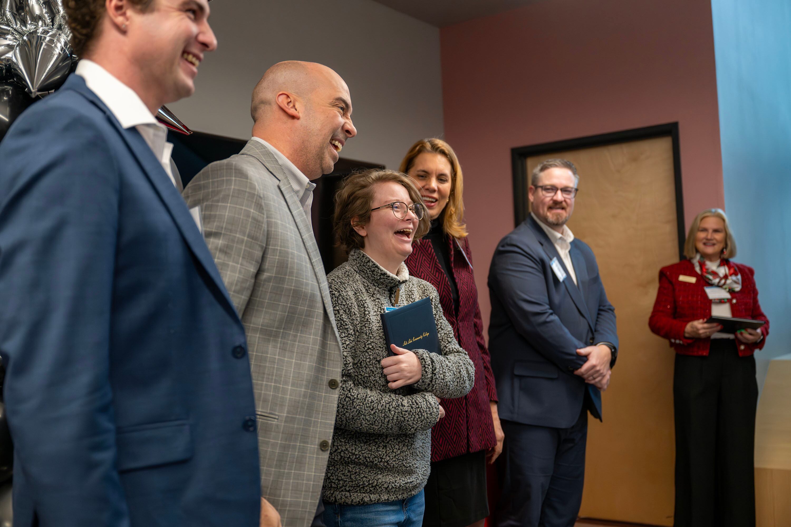 Alyvia Hurtado laughs with special guests during the inaugural graduation exercises of a SLCC-sponsored vocational training program for adults with autism at Nextwork Autism Program in South Salt Lake City, on Friday. The program aims to connect graduates to companies seeking their unique skill sets.