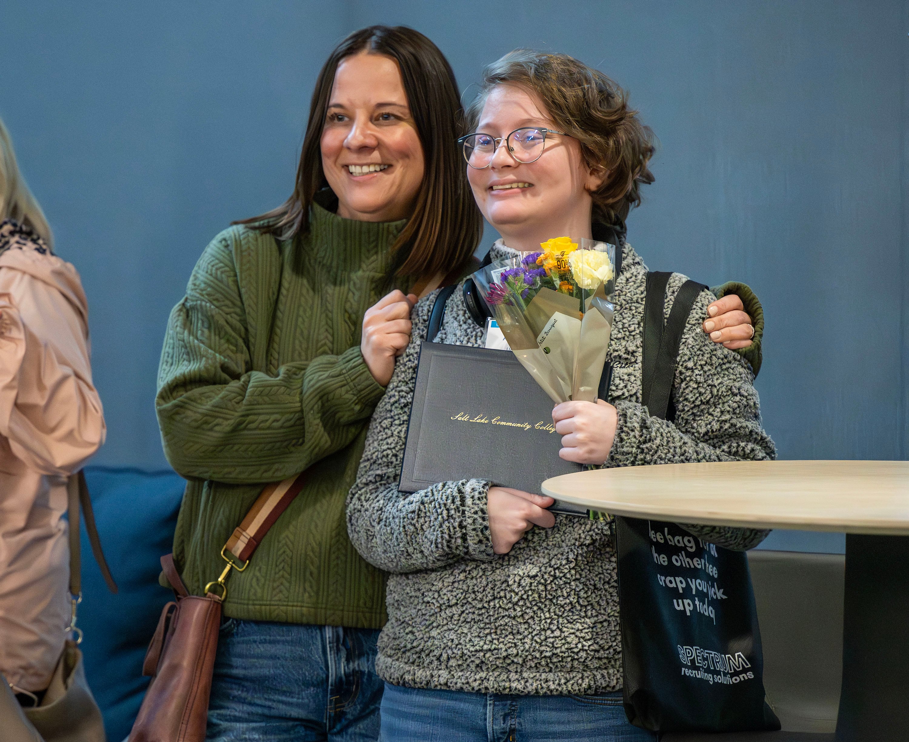 Sara Lovato poses with her daughter Alyvia Hurtado after the inaugural graduation exercises of a SLCC-sponsored vocational training program for adults with autism at Nextwork Autism Program in South Salt Lake City, on Friday. The program aims to connect graduates to companies seeking their unique skill sets.